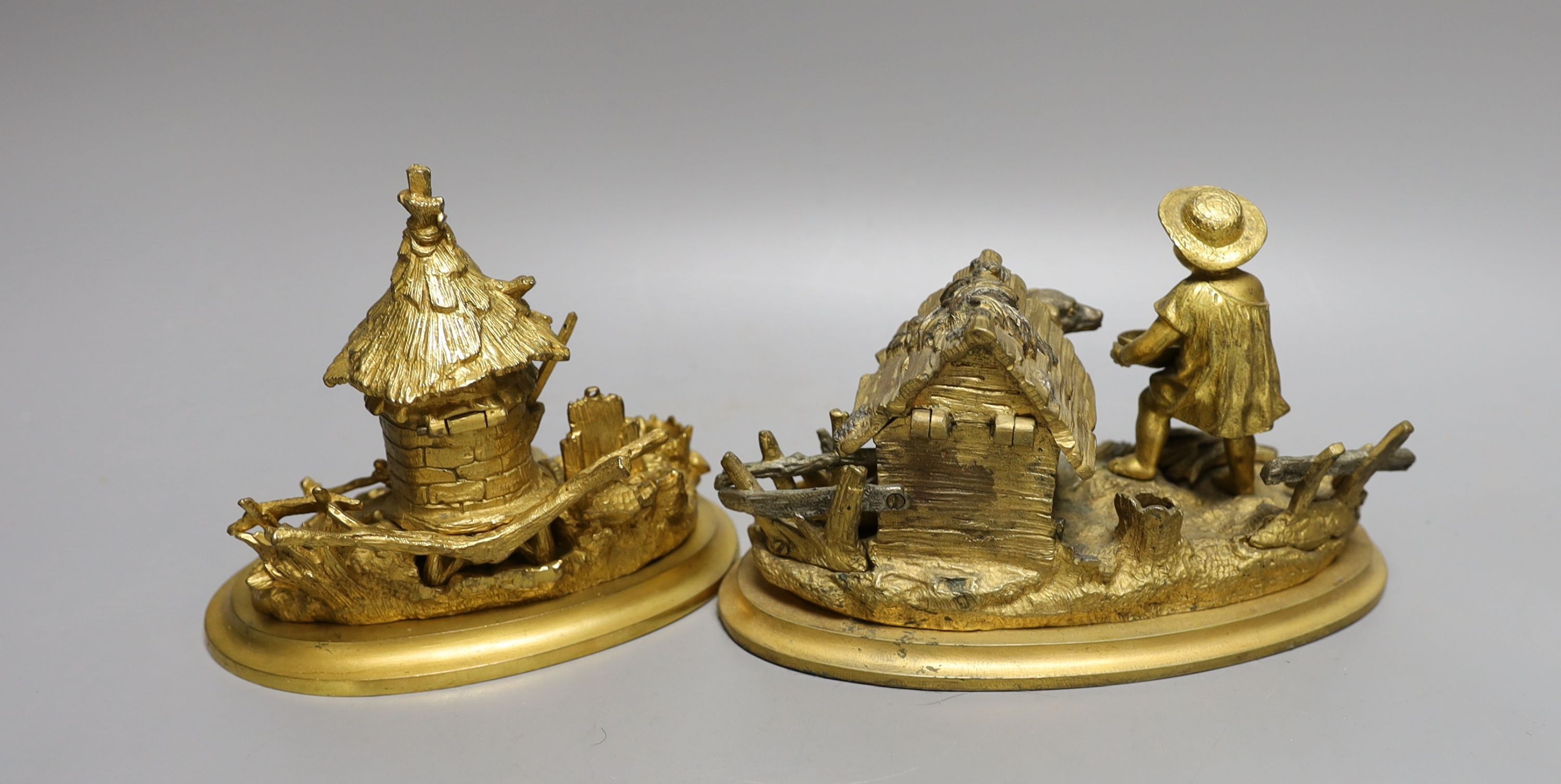 Two 19th century ormolu inkwells, modelled as a dog in a kennel, a water mill together with a chamberstick